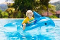 Child in swimming pool. Kid on inflatable float Royalty Free Stock Photo