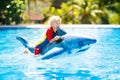 Child in swimming pool. Kid on inflatable float Royalty Free Stock Photo