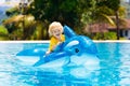 Child in swimming pool. Kid on inflatable float Royalty Free Stock Photo