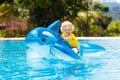 Child in swimming pool. Kid on inflatable float Royalty Free Stock Photo