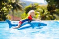 Child in swimming pool. Kid on inflatable float Royalty Free Stock Photo