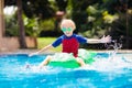 Child in swimming pool. Kid on inflatable float Royalty Free Stock Photo