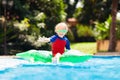 Child in swimming pool. Kid on inflatable float Royalty Free Stock Photo