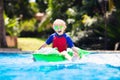 Child in swimming pool. Kid on inflatable float Royalty Free Stock Photo