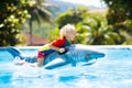 Child in swimming pool. Kid on inflatable float Royalty Free Stock Photo