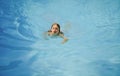 Child swimming in pool. Kids summer. Summertime attractions. Swimmingpool. Royalty Free Stock Photo