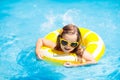 Child in swimming pool on ring toy. Kids swim Royalty Free Stock Photo