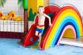 Child on swimming pool slide. Kids swim. Water fun Royalty Free Stock Photo