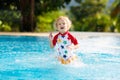 Child in swimming pool. Summer vacation with kids Royalty Free Stock Photo