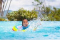 Child in swimming pool on toy ring. Kids swim Royalty Free Stock Photo