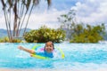 Child in swimming pool on toy ring. Kids swim Royalty Free Stock Photo