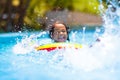 Child in swimming pool on toy ring. Kids swim Royalty Free Stock Photo