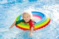 Child in swimming pool on toy ring. Kids swim Royalty Free Stock Photo