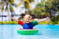 Child in swimming pool on toy ring. Kids swim Royalty Free Stock Photo