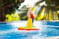 Child in swimming pool on toy ring. Kids swim Royalty Free Stock Photo