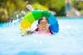 Child in swimming pool on toy ring. Kids swim Royalty Free Stock Photo