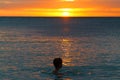 A child swimming at sunset, Fiji