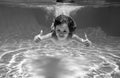 Child swimming underwater with thumbs up. Underwater kid swim under water. Child boy swimming and diving underwater in Royalty Free Stock Photo