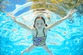 Child swims in pool underwater, girl has fun in water Royalty Free Stock Photo