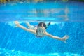 Child swims in pool underwater, happy active girl has fun Royalty Free Stock Photo