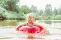 a child swims in the river in an inflatable circle Royalty Free Stock Photo