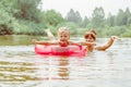 a child swims in the river in an inflatable circle Royalty Free Stock Photo