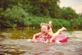 a child swims in the river in an inflatable circle Royalty Free Stock Photo