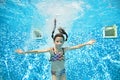 Child swims in swimming pool underwater, little active girl jumps, dives and has fun under water, kids fitness and sport Royalty Free Stock Photo