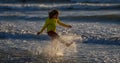 Child in swimwear running into sea water during summer holidays. Child running along ocean. Child on summer beach. Kid Royalty Free Stock Photo