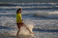 Child in swimwear running into sea water during summer holidays. Child running along ocean. Child on summer beach. Kid Royalty Free Stock Photo