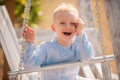 Child swing on backyard. Kid playing oudoor. Happy cute little boy swinging and having fun healthy summer vacation Royalty Free Stock Photo