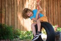 Child swing on backyard. Kid playing oudoor. Happy cute little boy swinging and having fun healthy summer vacation Royalty Free Stock Photo