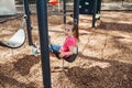 Child on a swing. Child playing on outdoor playground.