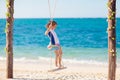 Child on swing. Kid swinging on beach Royalty Free Stock Photo