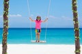 Child on swing. Kid swinging on beach Royalty Free Stock Photo