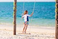 Child on swing. Kid swinging on beach Royalty Free Stock Photo