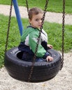 Child on swing at playground Royalty Free Stock Photo