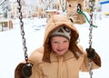 Child on swing in winter park Royalty Free Stock Photo