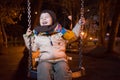 Child swinging at night