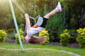 Child swinging on playground. Kids swing Royalty Free Stock Photo