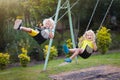 Child swinging on playground. Kids swing Royalty Free Stock Photo