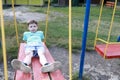 Child swinging on swing in park Royalty Free Stock Photo