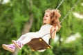 Child swinging on a swing at playground in the park. Royalty Free Stock Photo