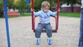 A child swinging on a swing on the Playground