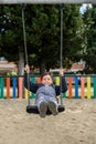 Child swings while sitting on a swing