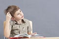 The child at the table is doing homework. Royalty Free Stock Photo