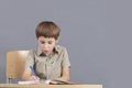The child at the table is doing homework. Royalty Free Stock Photo