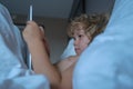 Child with tablet in bed. Parental permission, safety online internet for kids. Boy playing games. Social and technology