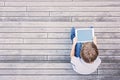 Child with tablet computer sitting outdoors. Top view Royalty Free Stock Photo