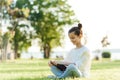 Child with tablet pc outdoors. Little girl on grass with computer Royalty Free Stock Photo